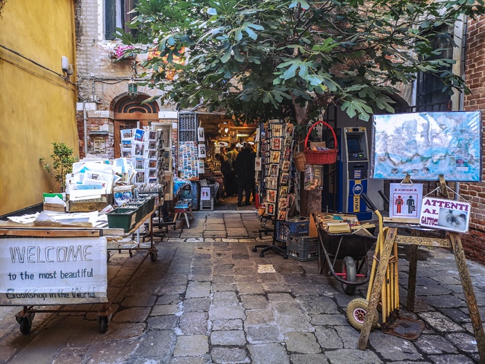 The entrance to Libreria Acqua Alta in Venice Italy, a bookshop very different to anything else you have experienced.