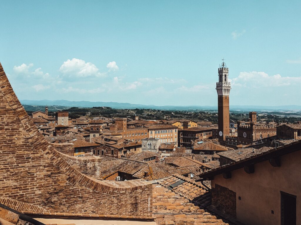 The Torre Del Mangia in Siena has views out across the city to the rolling Tuscan Hills beyond.