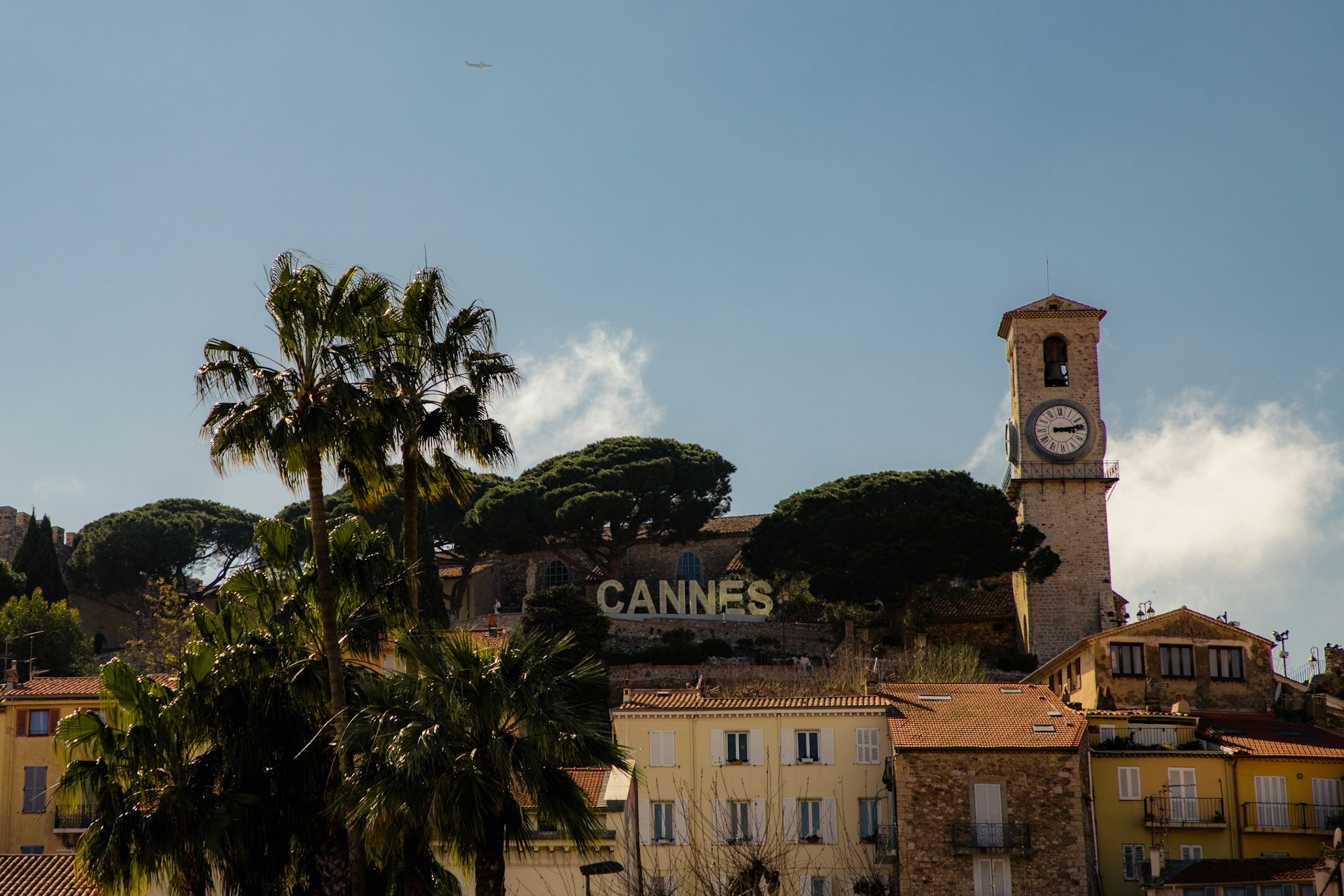 Cannes in the South of France with the old church showing next to the Cannes sign