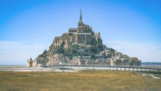 Mont Saint Michel in Normandy, Northern France, is a tidal island and home to a small commune of people.