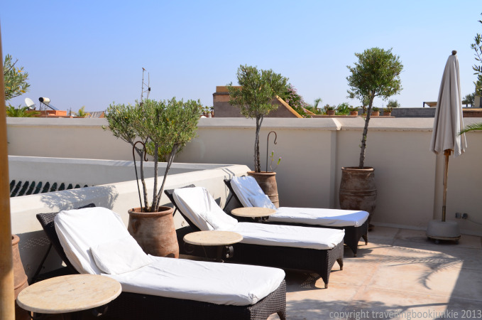 relaxing on sunloungers on the roof terrace of Riad camilia, Marrakech, Morocco