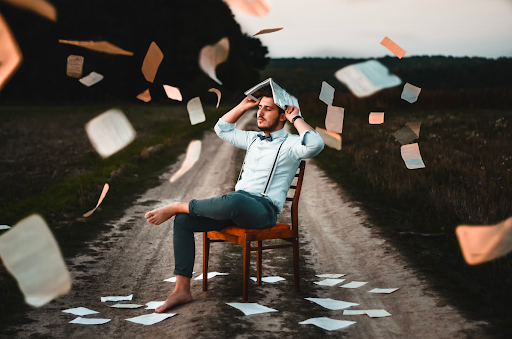 Man holding a book above his head trying to gain knowledge could be a symbol for travel as a student